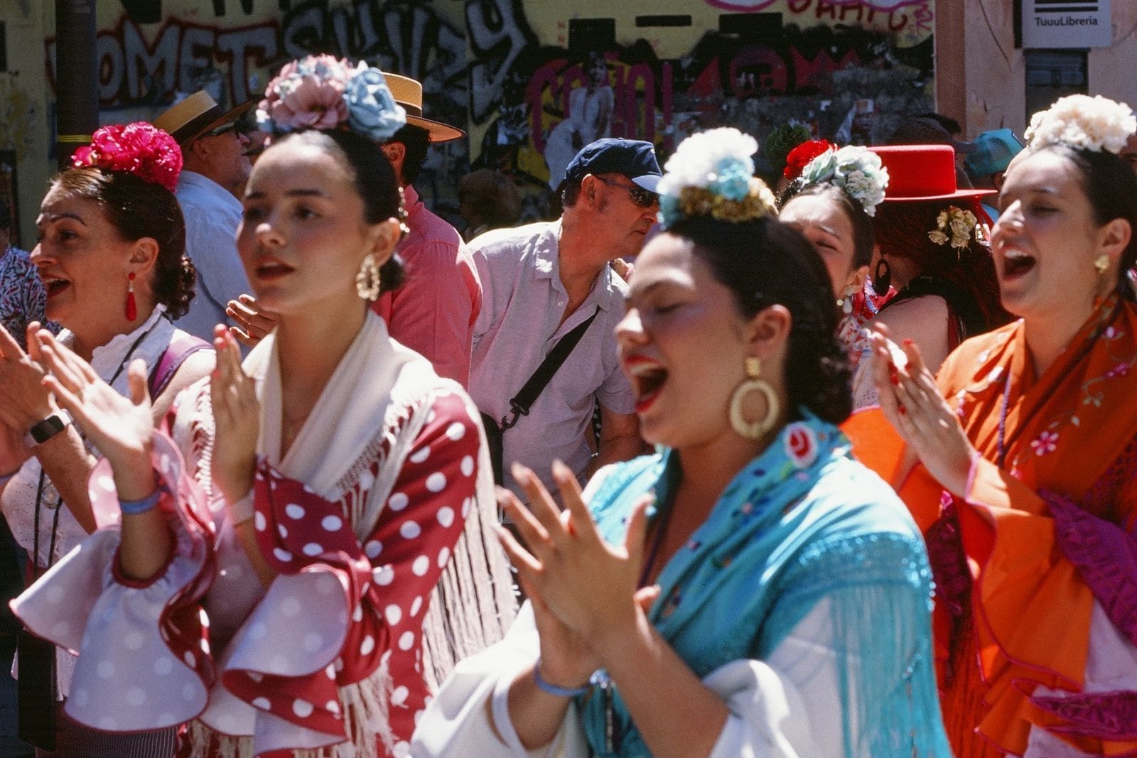 Dancers in traditional flamenco dresses at an outdoor festival