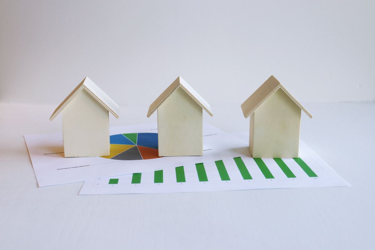 Property investment growth shown with house models and a chart