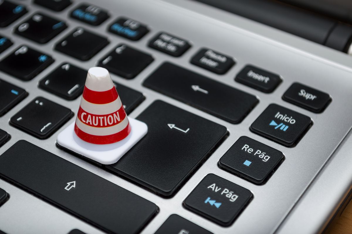 Caution sign on a keyboard - how to avoid property scams in Spain